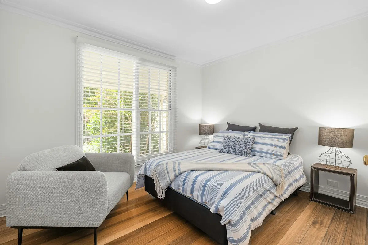 Quiet furnished bedroom with a reading chair