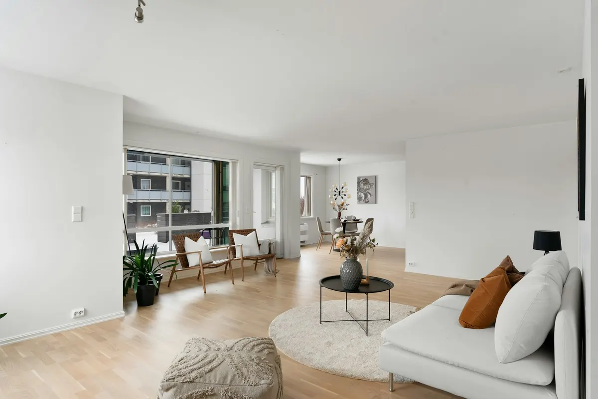 Sunlit furnished living room with comfortable seating